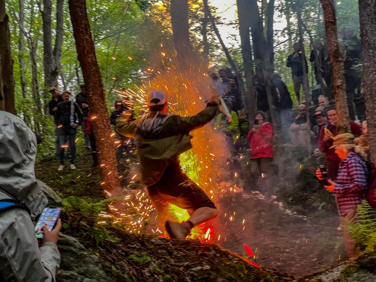 Crazy man jumping over firecracker in woods