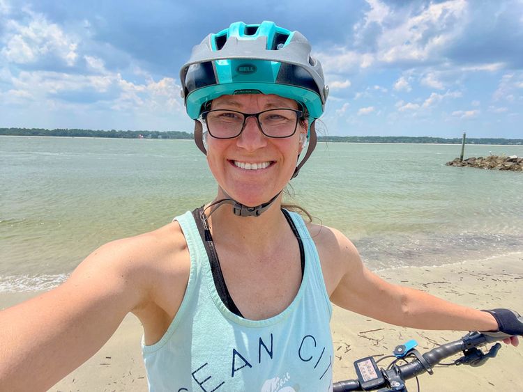 Victoria Weeks on Hilton Head beach wearing a tank top and helmet.